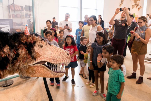 Dinosaur puppet with visitors