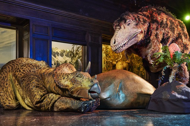 Life size realistic dinosaur puppets depicted during dinosaur encounters performance. 