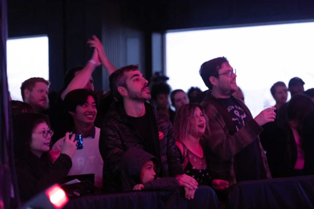 Crowd looking up and raising their arms