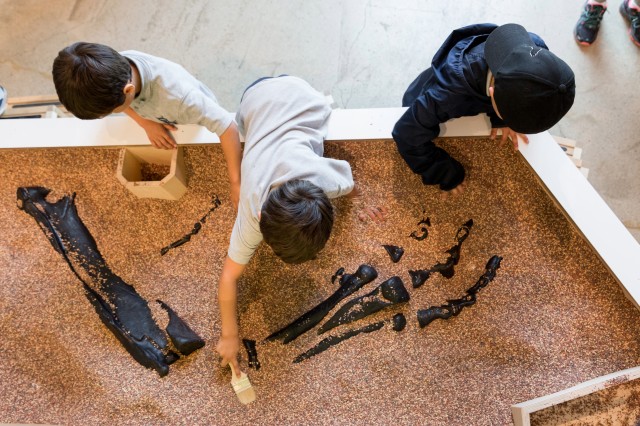 Students excavating in Discovery Center