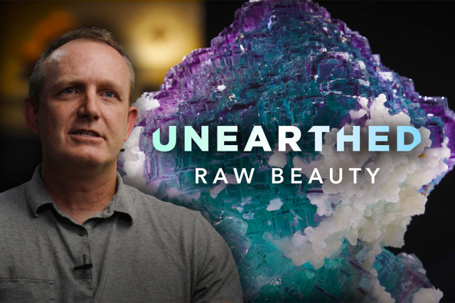 Aaron Celestian in front of purple and aqua crystallized mineral specimen