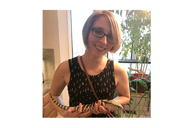Head and shoulders portrait of Paul Emily Patellos holding a snake