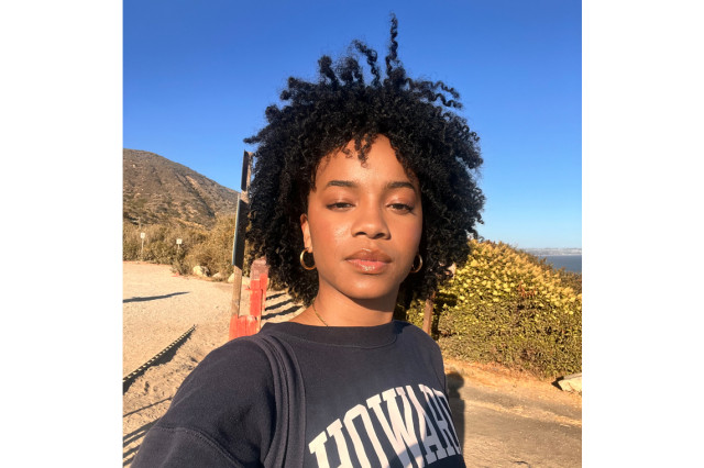Kendall Buycks wearing a black sweatshirt with Howard in white capital letters with hills and blue sky in the background