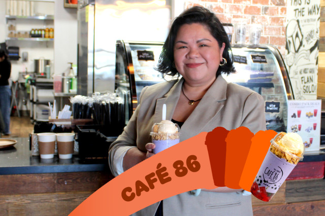 Filipino woman holding out a colorful boba drink in front of the counter at her cafe.