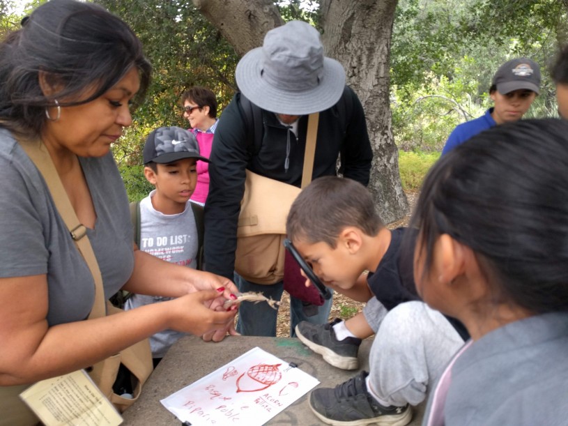 Brenda Kyle working with kids at a nature event.