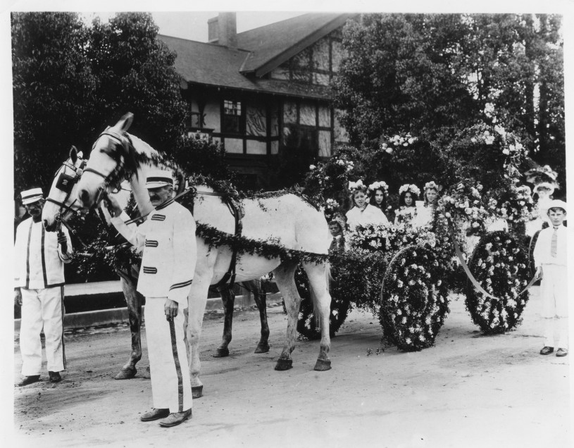 Girls in decorated horse and cart Tournament of Roses