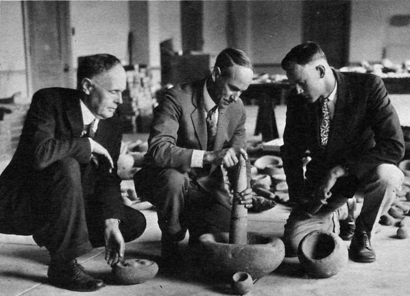 A. R. Sanger, C. W. Hatton, and Bruce Bryan looking at artifacts recovered during the expedition to San Nicolas Island in 1926