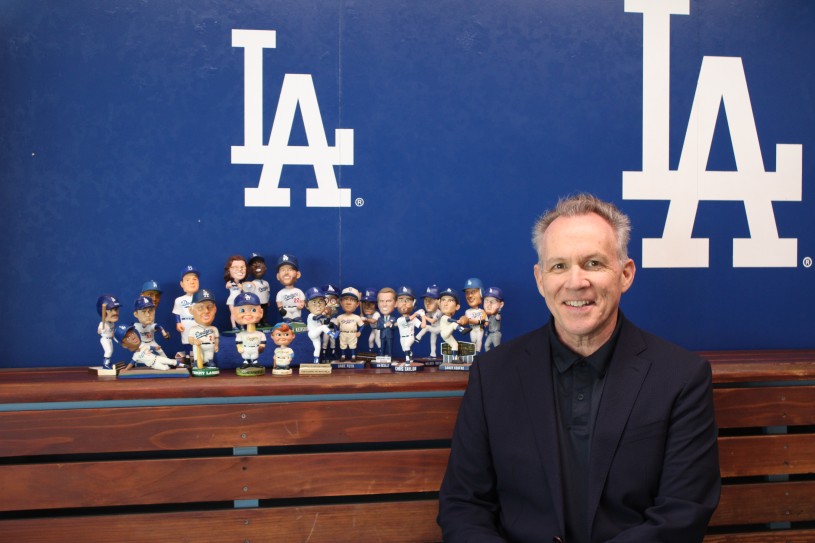 Mark poses with various bobbleheads 