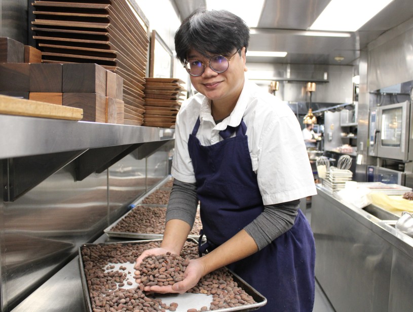 man in kitchen holding cacao nibs