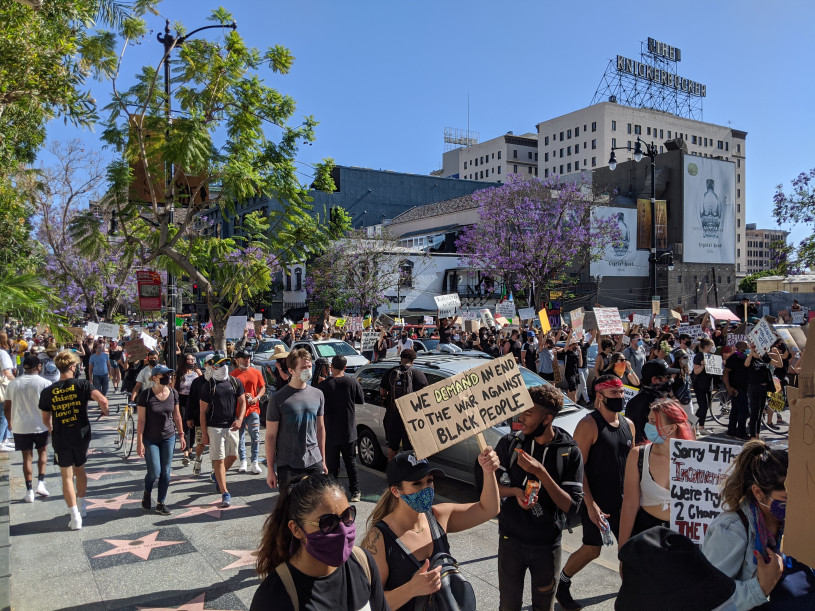 Large amounts of people protest  on Hollywood Blvd. holding up signs that demand an end to the war against black people.