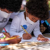 Image of guests participating in a drawing activity