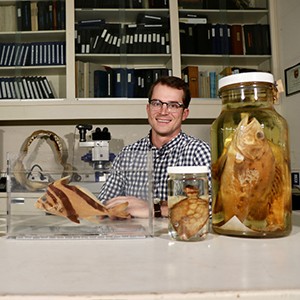 Head and shoulders portrait of Bill Ludt with specimens in jars