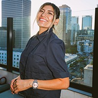 Brica Lopez in a black shirt with buildings in the background